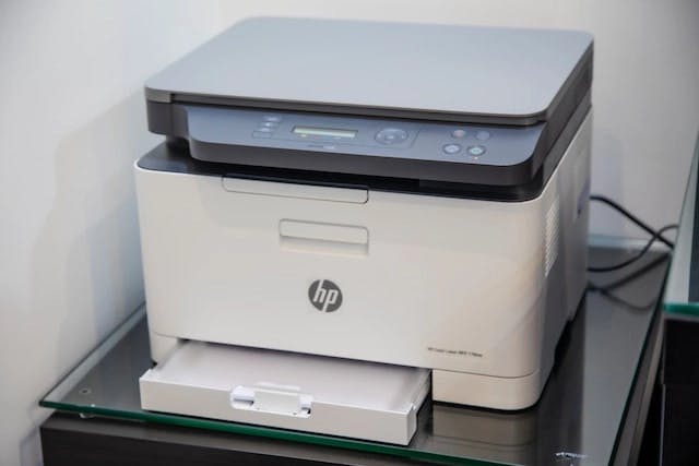 A white printer on a desk